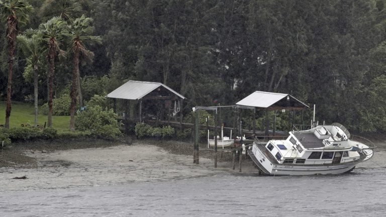  A boat rests on its side in what is normally six feet of water in Old Tampa Bay, Sunday, Sept. 10, 2017, in Tampa, Fla. Hurricane Irma, and an unusual low tide pushed water out into the Gulf of Mexico. (Chris O'Meara/AP Photo) 