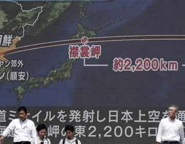  People walk past a public TV screen broadcasting news of North Korea's launch of missile, in Tokyo, Friday, Sept. 15, 2017. North Korea launched an intermediate-range missile that flew over Japan in its longest-ever flight on Friday, showing that leader Kim Jong Un is defiantly pushing to bolster his weapons programs despite U.S.-led international pressure. (Eugene Hoshiko/AP Photo) 