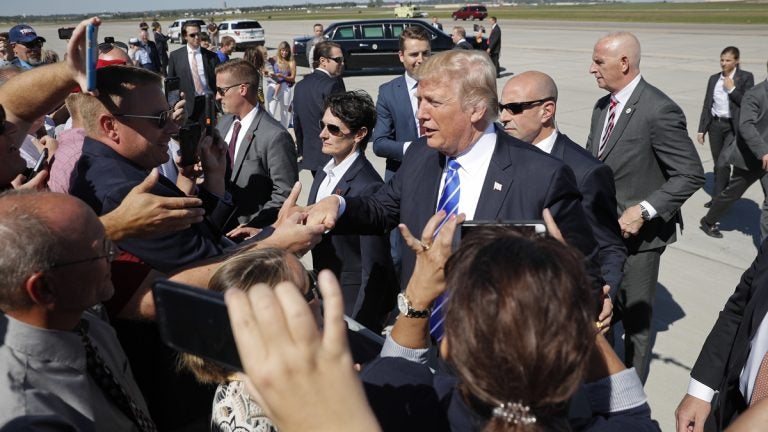 President Donald Trump greets supports on the tarmac upon his arrival at Bismarck Municipal Airport, Wednesday, Sept. 6, 2017 in Bismarck, N.D. Trump is in North Dakota to promote his tax overhaul pitch.