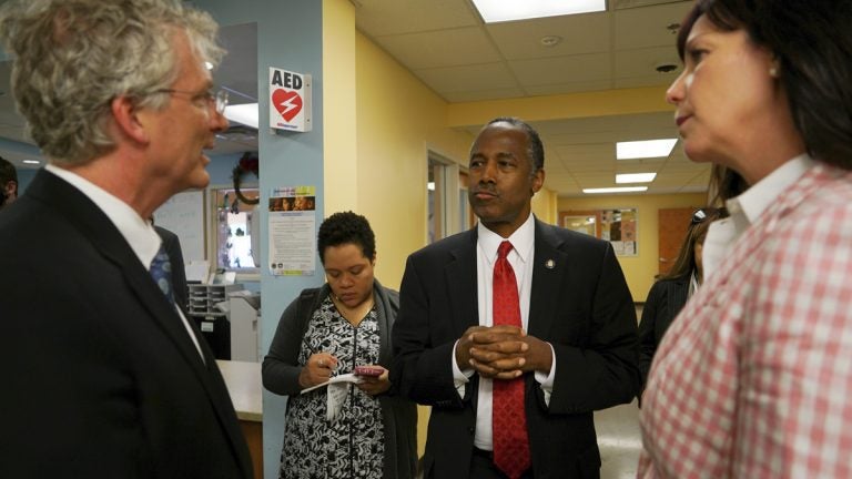 Ben Carson, secretary of Housing and Urban Development, is shown speaking with city and housing officials at a shelter in Columbus, Ohio, in April. (AP Photo/Dake Kang, file)