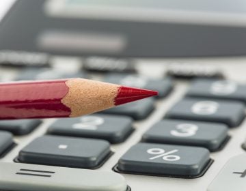 Red pencil and calculator