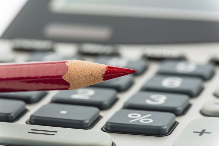 Red pencil and calculator