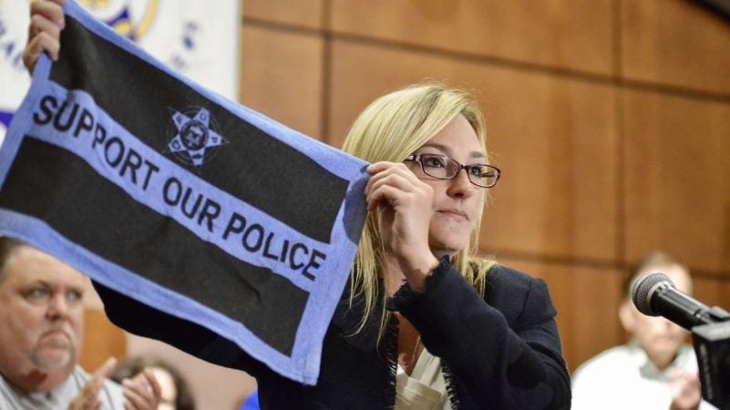 Pennsylvania State Rep. Martina White , R-Phila, waves a rally flag in support at a Back the Blue rally Thursday. She sponsored House Bill 1538 that aimed to shield the name of police officers involved in shootings. The bill was vetoed by Gov Tom Wolf.  (Bastiaan Slabbers for NewsWorks)