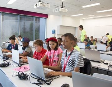 Participants work together to build different creations during the the inaugural Block by Block Party, a Minecraft gaming event and family science festival at USciences benefiting Philadelphia Public Schools. (Emily Cohen for WHYY)