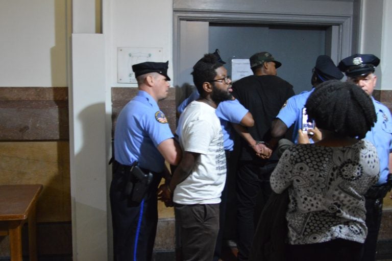  Two of the protesters are put on a freight elevator at City Hall after being removed from Council chambers. (Tom MacDonald/WHYY) 