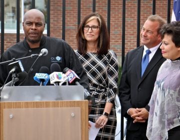  Mark Woodall (left), a former state prison inmate and current chef at Cathedral Kitchen, talks about the difficulty of finding permanent shelter during re-entry. With him are (from right) Camden County Freeholder Carmen Rodriguez, Freeholder Director Louis Cappelli Jr., and Volunteers of America Chief Operating Officer Pat McKernan, who announced a new plan to end homelessness. (Emma Lee/WHYY) 
