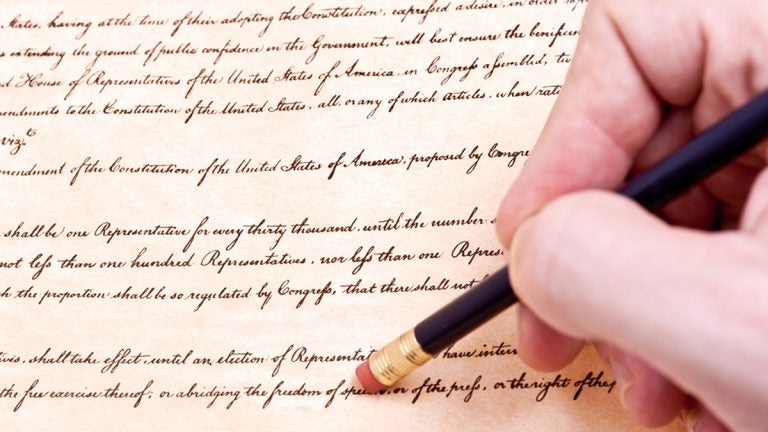  (<a href='https://www.bigstockphoto.com/image-24731483/stock-photo-closeup-of-hand-pencil-erasing-first-amendment-to-u-s-constitution'>Qingwa</a>/Big Stock Photo) 