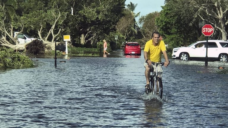  A man rides through storm water in Naples, Fla., in the aftermath of Hurricane Irma, Monday, Sept. 11, 2017. Florida Gov. Rick Scott says there's damage across the state caused by Hurricane Irma and it's still too dangerous for residents to go outside or return from evacuation. (AP Photo/Robert Ray) 