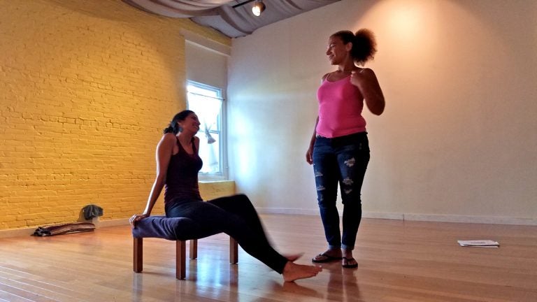 Bambi Friday (right), who was formerly incarcerated, works on a performance for the Fringe Arts Festival in which she expresses the struggles of re-entry. Seated is Natasha Cohen-Carroll, an associate of Theater of the Oppressed Philadelphia. (Peter Crimmins/WHYY)