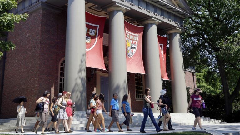  A tour group is shown walking through the campus of Harvard University in Cambridge, Mass. Word of an August 2017 Justice Department inquiry into how race factors into admissions at Harvard University has left top-tier colleges bracing for scrutiny of practices that have boosted diversity levels to new highs. (AP Photo/Elise Amendola, File)  