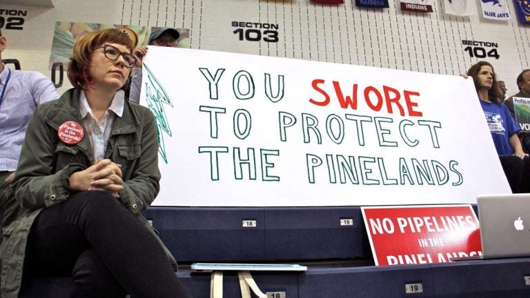  Protesters armed with signs fill the bleachers at Pine Belt Arena in Toms River, where the New Jersey Pinelands Commission held a public hearing on a proposed natural gas pipeline through Burlington and Ocean counties. (Emma Lee/WHYY) 