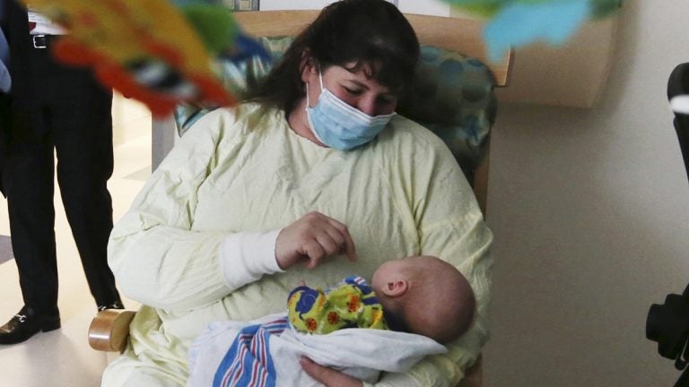 A woman holds her 49-day-old grandson who was being treated for neonatal drug withdrawal after his mother took opioids during pregnancy. The baby was treated at the Neonatal Intensive Care Unit at Jersey Shore University Medical Center in Neptune Township, New Jersey. (Mel Evans/AP Photo)