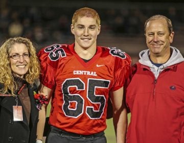 This Oct. 31, 2014, photo provided by Patrick Carns shows Timothy Piazza, (center), with his parents Evelyn and James Piazza, during Hunterdon Central Regional High School football's 'Senior Night' at the high school's stadium in Flemington, N.J. (Patrick Carns via AP)  