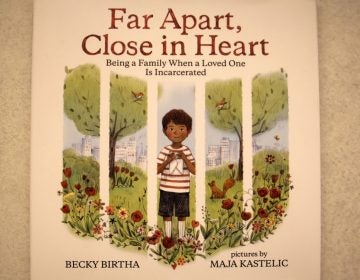 The cover of local author Becky Birtha's book evokes prison bars because it focuses on kids coping when their parents are incarcerated. (Emma Lee/WHYY)