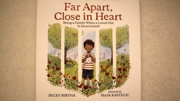 The cover of local author Becky Birtha's book evokes prison bars because it focuses on kids coping when their parents are incarcerated. (Emma Lee/WHYY)