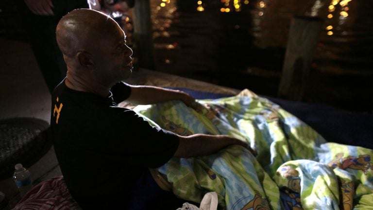 Homeless veteran James Thomas, 62, who was sleeping along the Miami River, talks with officials from the Veteran's Administration during the Point In Time Homeless Census, Thursday, Jan. 22, 2015, in Miami.
