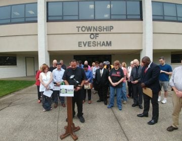 Religious leaders and community members pray outside the courthouse in Evesham, New Jersey.
