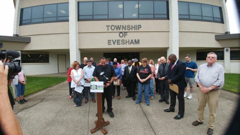 Religious leaders and community members pray outside the courthouse in Evesham, New Jersey.