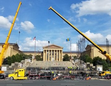  Workers set up the stage for the Made in America concert on the Ben Franklin Parkway. (Peter Crimmins/WHYY) 