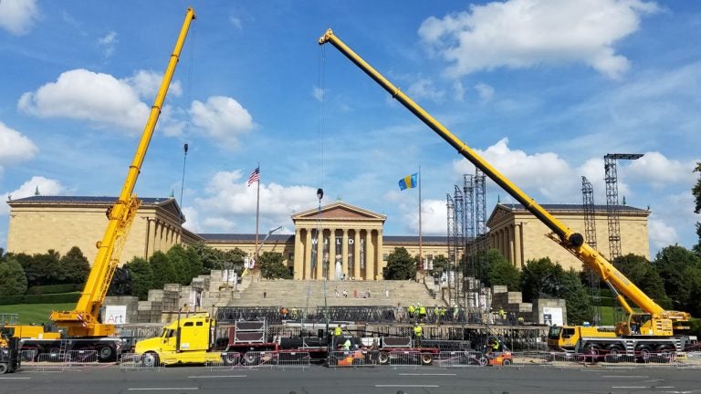  Workers set up the stage for the Made in America concert on the Ben Franklin Parkway. (Peter Crimmins/WHYY) 