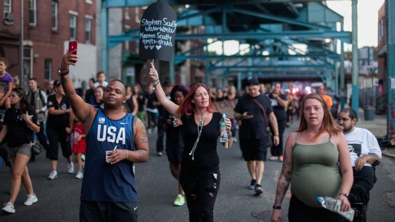 Hundreds march up Kensington Avenue Thursday for the March in Black in remembrance of those who have died from opioid overdoses. (Brad Larrison for NewsWorks)