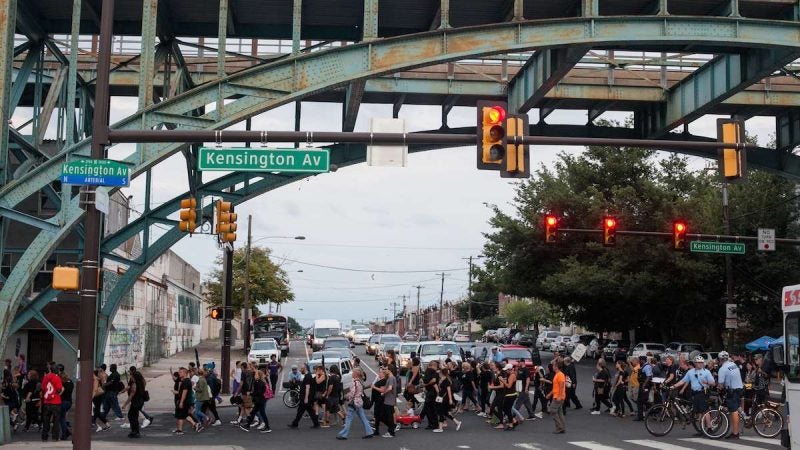 Hundreds march up Kensington Avenue Thursday for the March in Black in remembrance of those who have died from opioid overdoses. (Brad Larrison for NewsWorks)