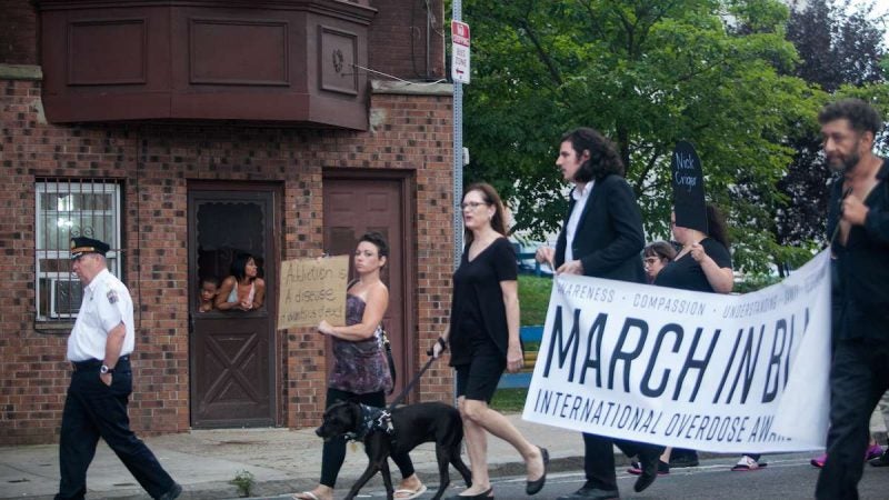 Hundreds march up Kensington Avenue Thursday for the March in Black in remembrance of those who have died from opioid overdoses. (Brad Larrisonf or NewsWorks)