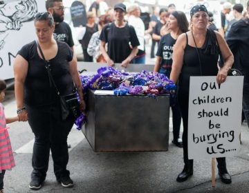 A casket is carried up Kensington Avenue Thursday during the March in Black in remembrance of those who have died of opioid overdoses in the Philadelphia region. (Brad Larrison for NewsWorks)