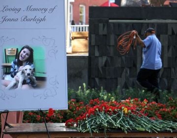 Carnations are piled beside a portrait of murder victim Jenna Burleigh after a memorial service at Temple University's Founder's Garden