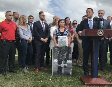 Pennsylvania Attorney General Josh Shapiro, flanked by people whose loved ones have been addicted to opioids, announces new details of a 41-state investigation into the role of pharmaceutical companies in the opioid epidemic. (Laura Banshoff/WHYY)