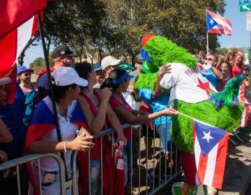 The Phillie Phanatic gives hugs on the Benjamin Franklin Parkway during the 2017 Puerto Rican Day Parade.