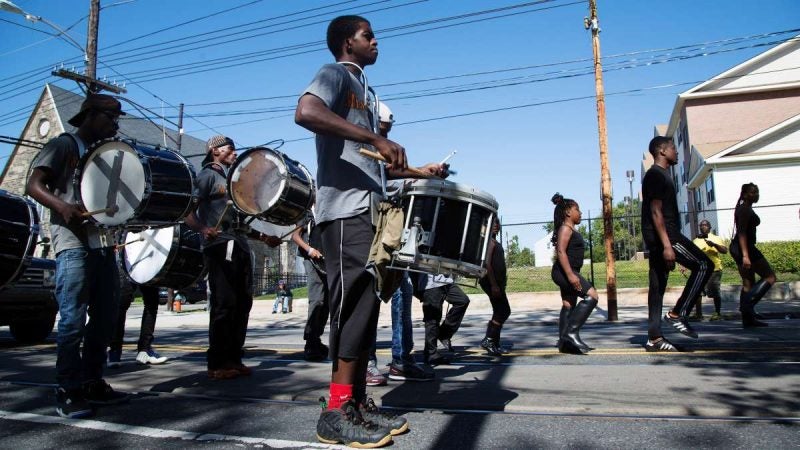 The Mass Konfusion drill team briefly marches in place before continuing on. (Annie Risemberg for NewsWorks)