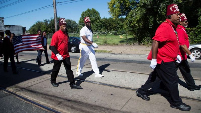 Members of the Pyramid Temple #1, the Prince Hall Shriners of Philadelphia, walk down Woodland Avenue at the start of the Southwest Pride Day parade. The Shriners are a fraternity best known for administering the Shriners Hospital for Children. (Annie Risemberg for NewsWorks)