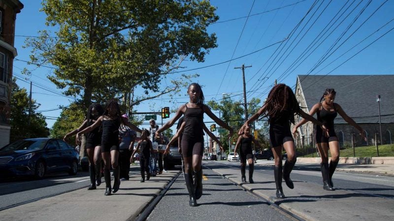 The Mass Konfusion drill team makes their way down Woodland Avenue during the Southwest Pride Day parade. (Annie Risemberg for NewsWorks)