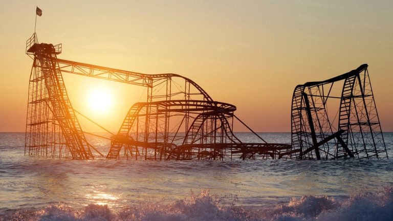  FILE - In this Feb. 25, 2013 photo, the sun rises in Seaside Heights, N.J., behind the Jet Star Roller Coaster which fell into the ocean during Superstorm Sandy. In May 2013 it was dismantled and removed. (AP Photo/Mel Evans, File) 