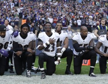 Baltimore Ravens players kneel down during the playing of the U.S. national anthem before an NFL football game against the Jacksonville Jaguars at Wembley Stadium in London, Sunday Sept. 24, 2017. (AP Photo/Matt Dunham)