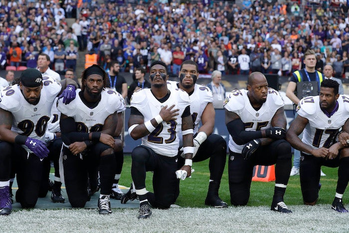 Baltimore Ravens players kneel down during the playing of the U.S. national anthem before an NFL football game against the Jacksonville Jaguars at Wembley Stadium in London, Sunday Sept. 24, 2017. (AP Photo/Matt Dunham)