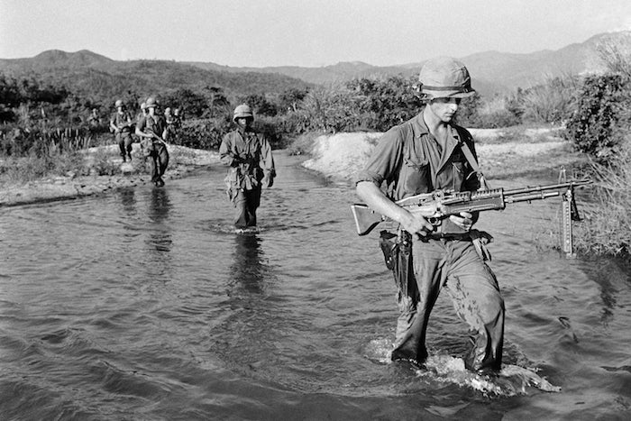 U.S. Marines walking through the stream during a patrol 15 miles southwest of Da Nang airbase in Vietnam on Thursday, May 20, 1965, in a newly assigned territory to the American Marines. (AP Photo/John T. Wheeler)