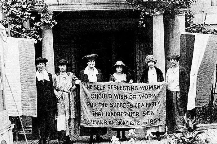 Chairwoman Alice Paul, second from left, and officers of the National Woman's Party hold a banner with a Susan B. Anthony quote in front of the NWP headquarters in Washington, D.C., June 1920.  The suffragettes are ready for the G.O.P. convention to seek support for the ratification of the 19th Amendment granting women the right to vote. The other suffragettes are, Sue White, Mrs. Benigna Green Kalb, Mrs. James Rector, Mary Dubrow and Elizabeth Kalb.  (AP Photo)