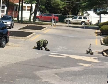 A state trooper examining what was discovered to be an imitation explosive device in Toms River Thursday morning. (Photo: Toms River Police Department)