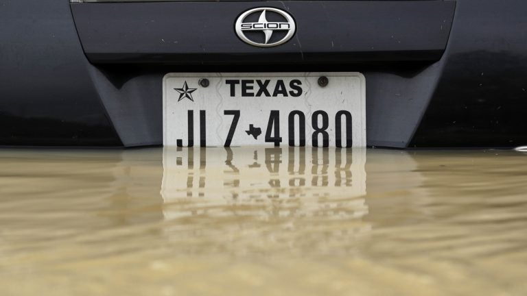 A car sits in floodwater from Tropical Storm Harvey rise Wednesday, Aug. 30, 2017, in Houston. (AP Photo/Gregory Bull)