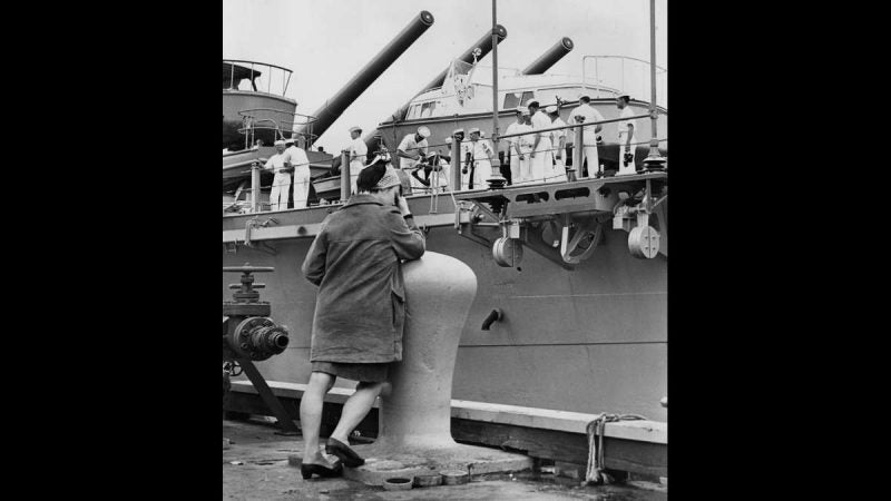 The U.S.S. New Jersey pulls away from the Philadelphia Naval Shipyard on May 16, 1968, to begin a tour of active duty as the downhearted girlfriend of one sailor covers her eyes. (Dominic Ligato / Courtesy of George D. McDowell Philadelphia Evening Bulletin Collection, Temple University Libraries)