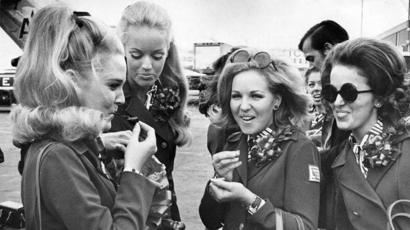 Miss America, Pamela Anne Eldred, shares a bag of cherries she brought from Atlantic City for the trip with Susan Anton, Miss California; Mary Cox, Miss Tennessee; and Ann Fowler, Miss Alabama, just before boarding their flight on Aug. 10, 1970. (Raymond F. Stubblebine / Courtesy of George D. McDowell Philadelphia Evening Bulletin Collection, Temple University Libraries)