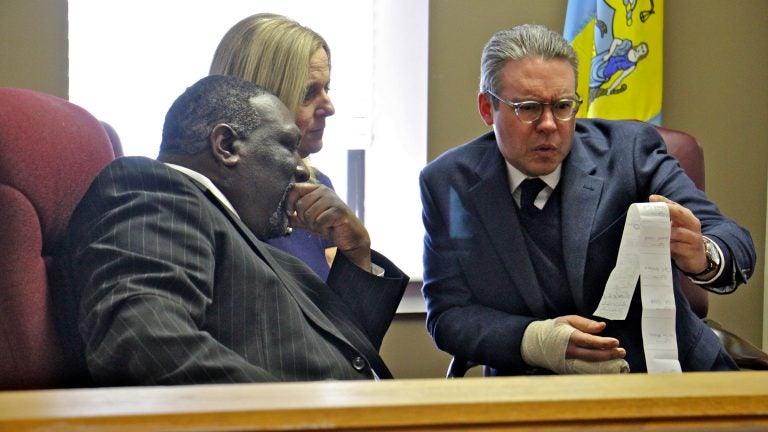  Philadelphia City Commissioners (from left) Anthony Clark, Lisa Deeley, and Al Schmidt, review write-in votes from the 197th legislative district special election in which more than 90 percent of the votes were write-ins. (Emma Lee/WHYY) 