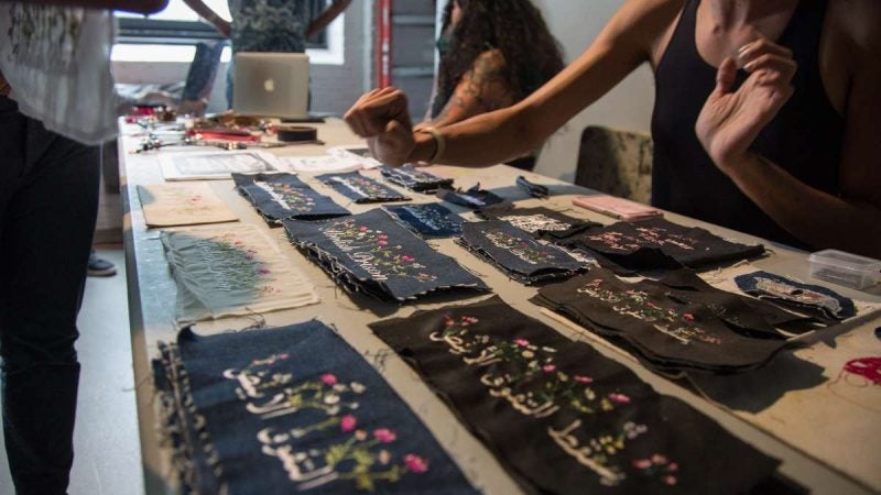 Rose Buttress sells her embroidered goods in the vendor section of YallaPunk. (Emily Cohen for WHYY)