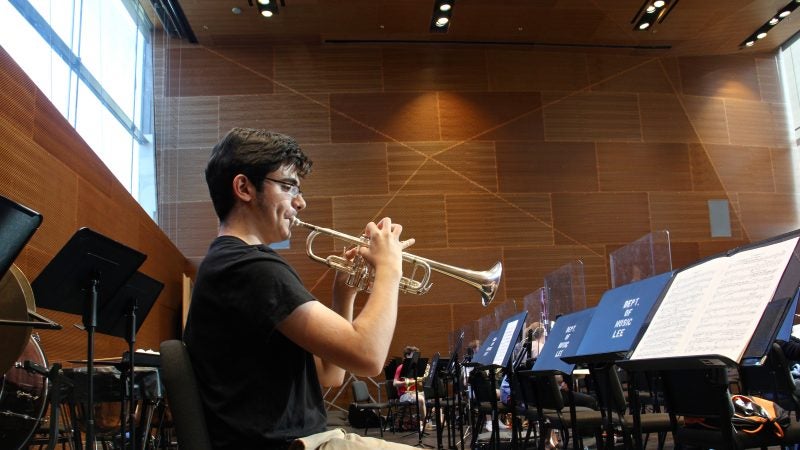 A trumpeter warms up in the Lee Music Performance and Rehearsal Room. (Emma Lee/WHYY)