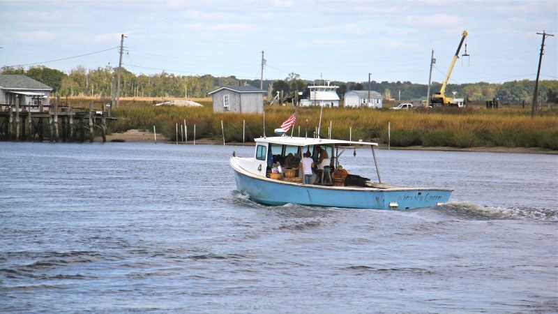 A fishing boat sets out from Money Island.