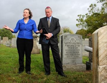 Naomi Adler, CEO of the Jewish Federation of Greater Philadelphia, sings a prayer during a visit to Mt. Carmel Cemetery with Mayor Jim Kenney, who toured the site to see the repairs made to vandalized tombstones