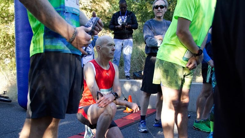 Kevin Peter, of West Mt. Airy, takes a knee in protest during the National Anthem at the start of the WXPN 5K, on Sunday. (Bastiaan Slabbers for WHYY)