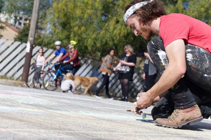 Daniel Lipschutz, of South Philadelphia, volunteers with Mural Arts Program during Philly Free Streets, Saturday, Oct. 28, 2017. Cyclists and pedestrians take part in Philly Free Streets event, Saturday, Oct. 28, 2017. (Bastiaan Slabbers for WHYY)